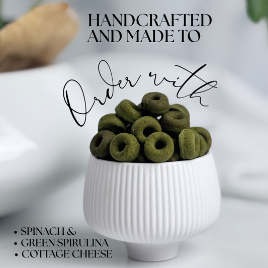 Superfood Spinach, Green Spirulina and Cottage Cheese Healthy Dog Treats in the shape of mini donuts. We call them Daisy Loops a playful color reference to Fruit Loops but for dogs.